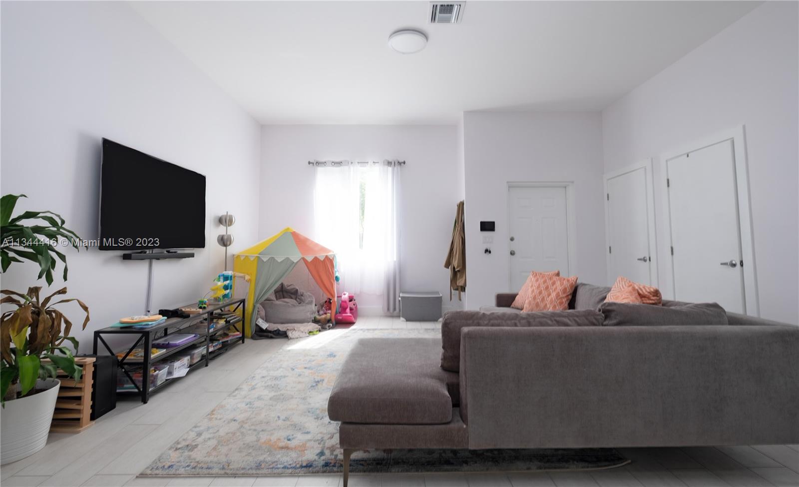 2734 Southwest 26th Street, Unit 2734 Miami, FL 33133 - Photo 6 of 41 a living room with furniture and a flat screen tv
