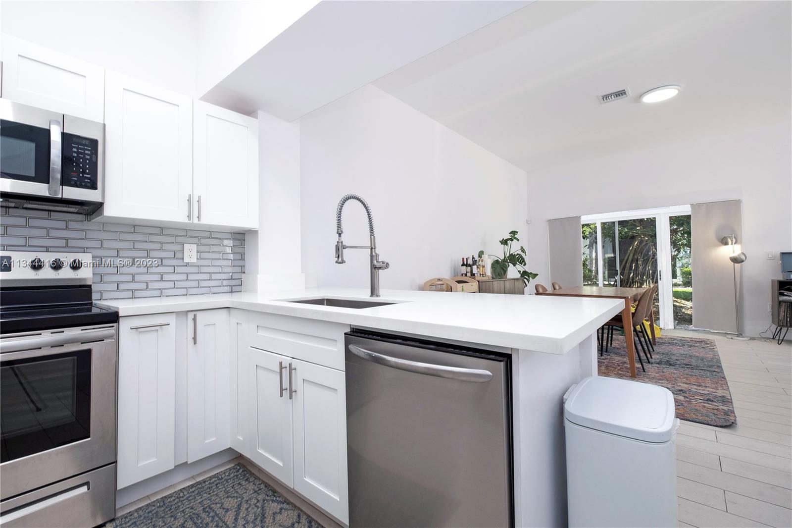 2734 Southwest 26th Street, Unit 2734 Miami, FL 33133 - Photo 10 of 41 a kitchen with a sink stove and cabinets