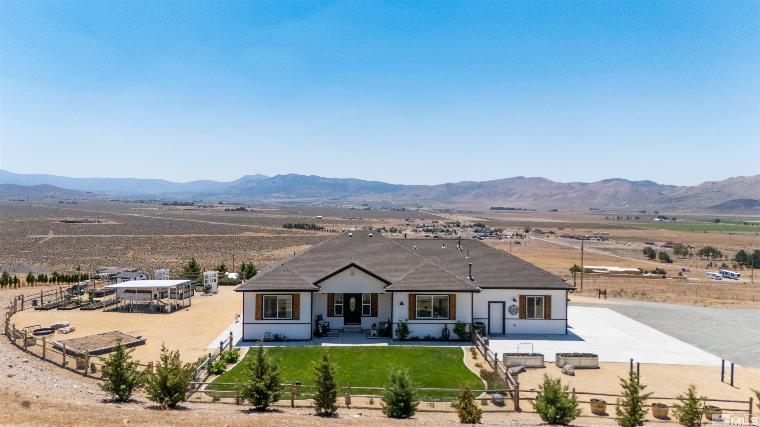 205 Bootstrap Lane Reno, NV 89510 - Photo 1 of 39 an aerial view of a house with a garden and lake view