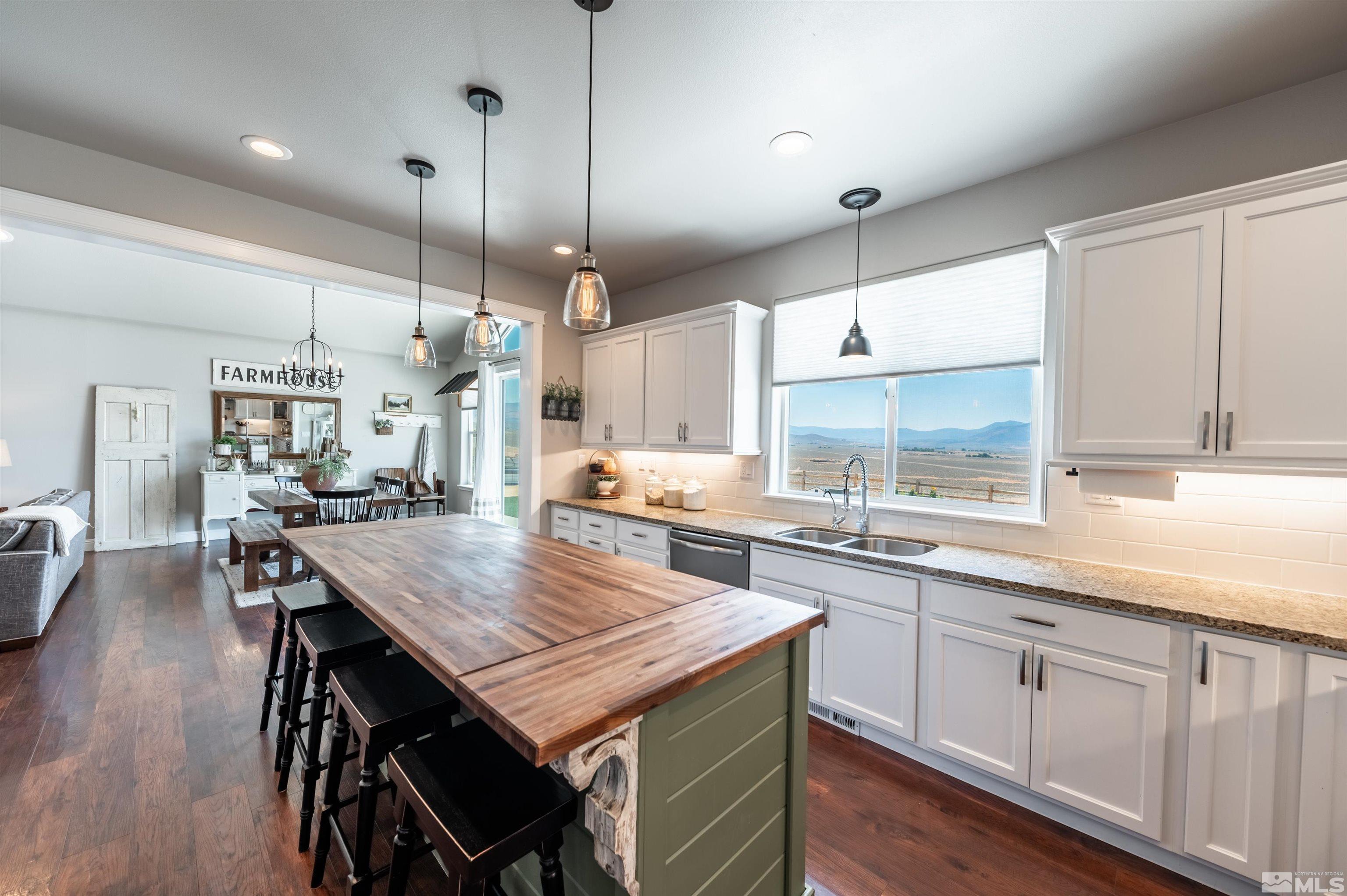 205 Bootstrap Lane Reno, NV 89510 - Photo 12 of 39 a kitchen with granite countertop a table chairs stainless steel appliances and cabinets