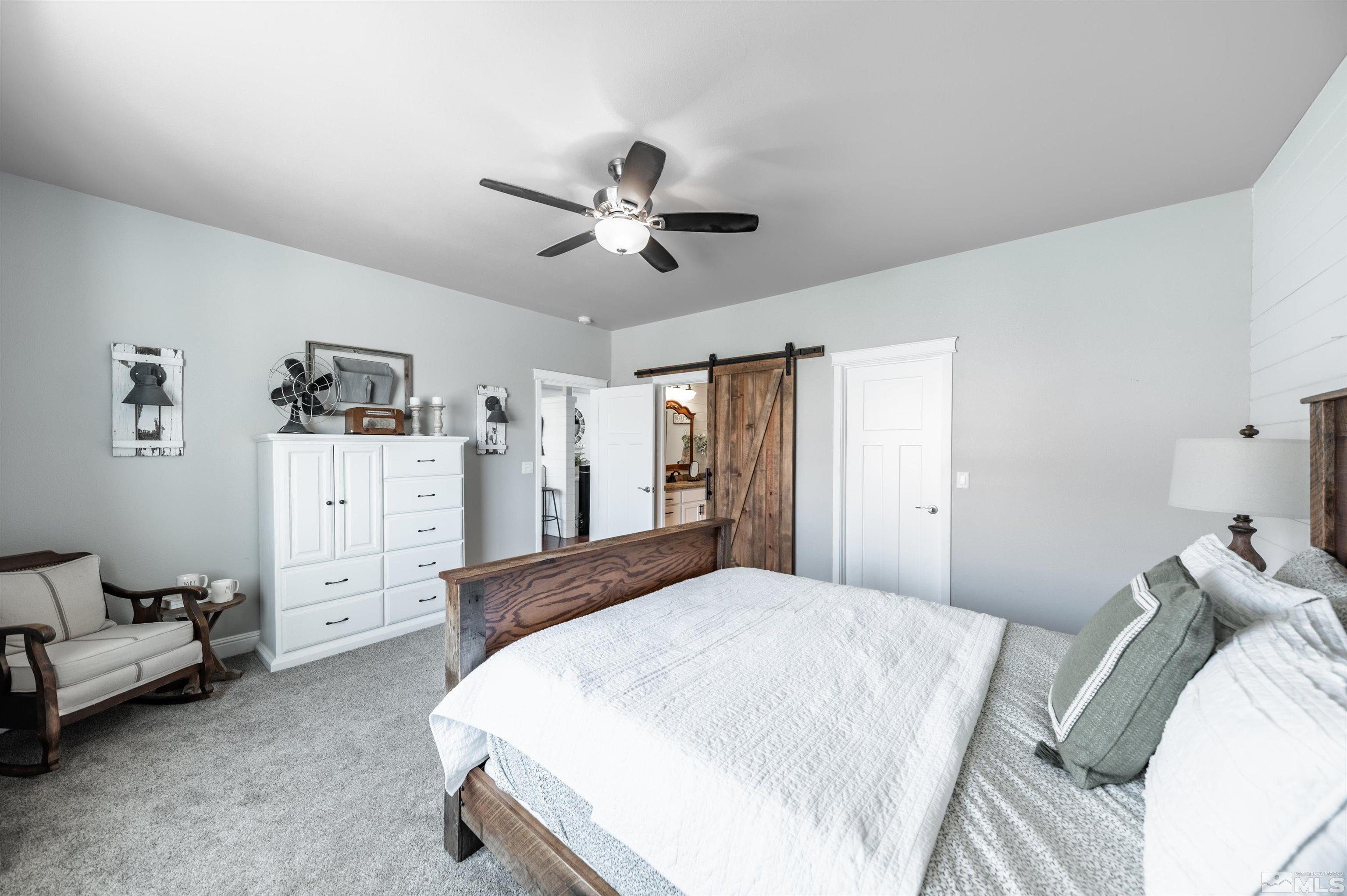 205 Bootstrap Lane Reno, NV 89510 - Photo 16 of 39 a spacious bedroom with a bed and a couch