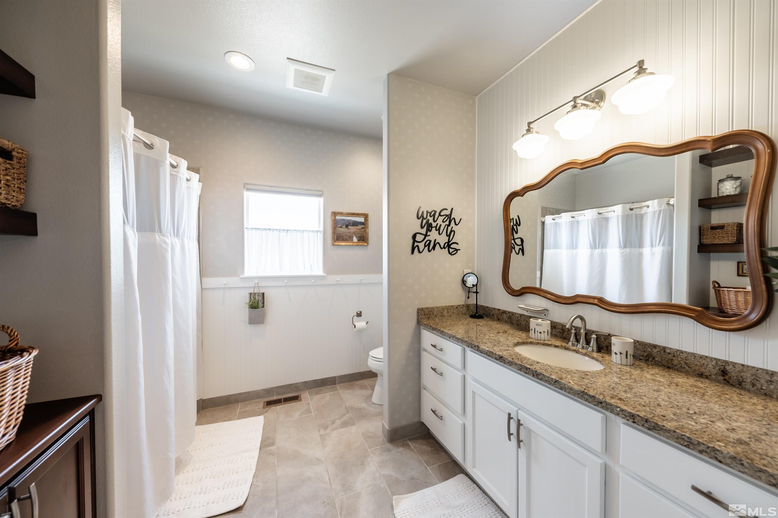 205 Bootstrap Lane Reno, NV 89510 - Photo 19 of 39 a bathroom with a granite countertop double vanity sink and mirror