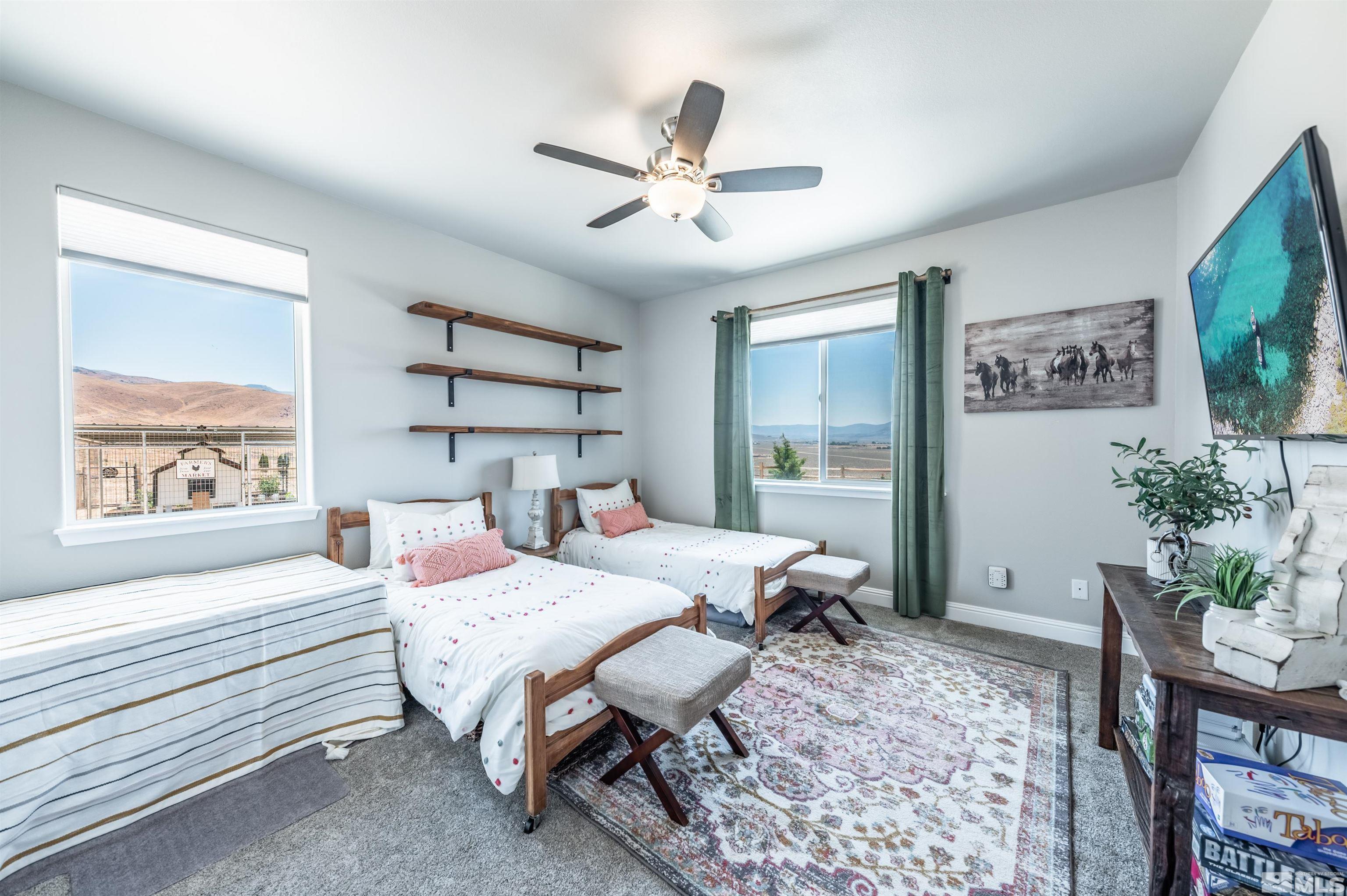 205 Bootstrap Lane Reno, NV 89510 - Photo 20 of 39 a bedroom that has a bed and a table in it