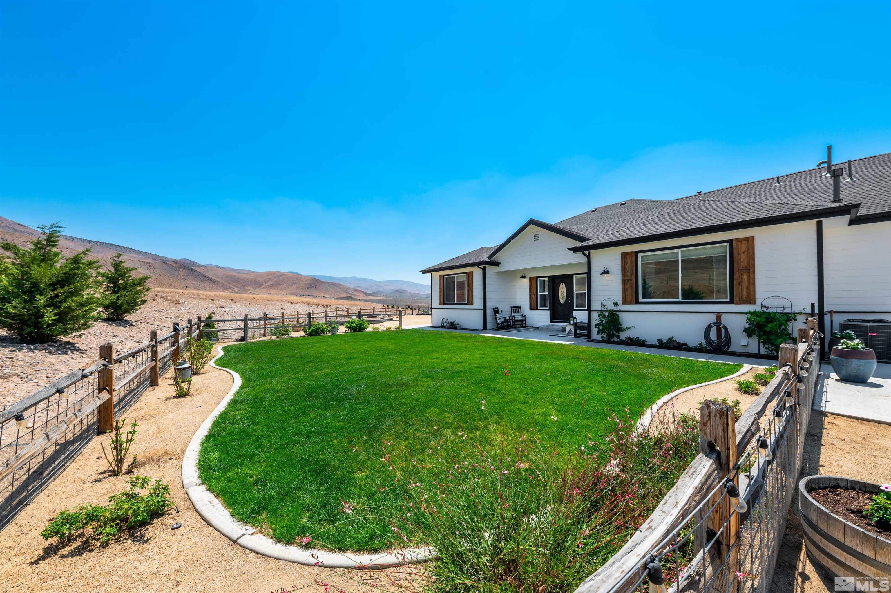 205 Bootstrap Lane Reno, NV 89510 - Photo 8 of 39 a view of a patio with table and chairs under an umbrella