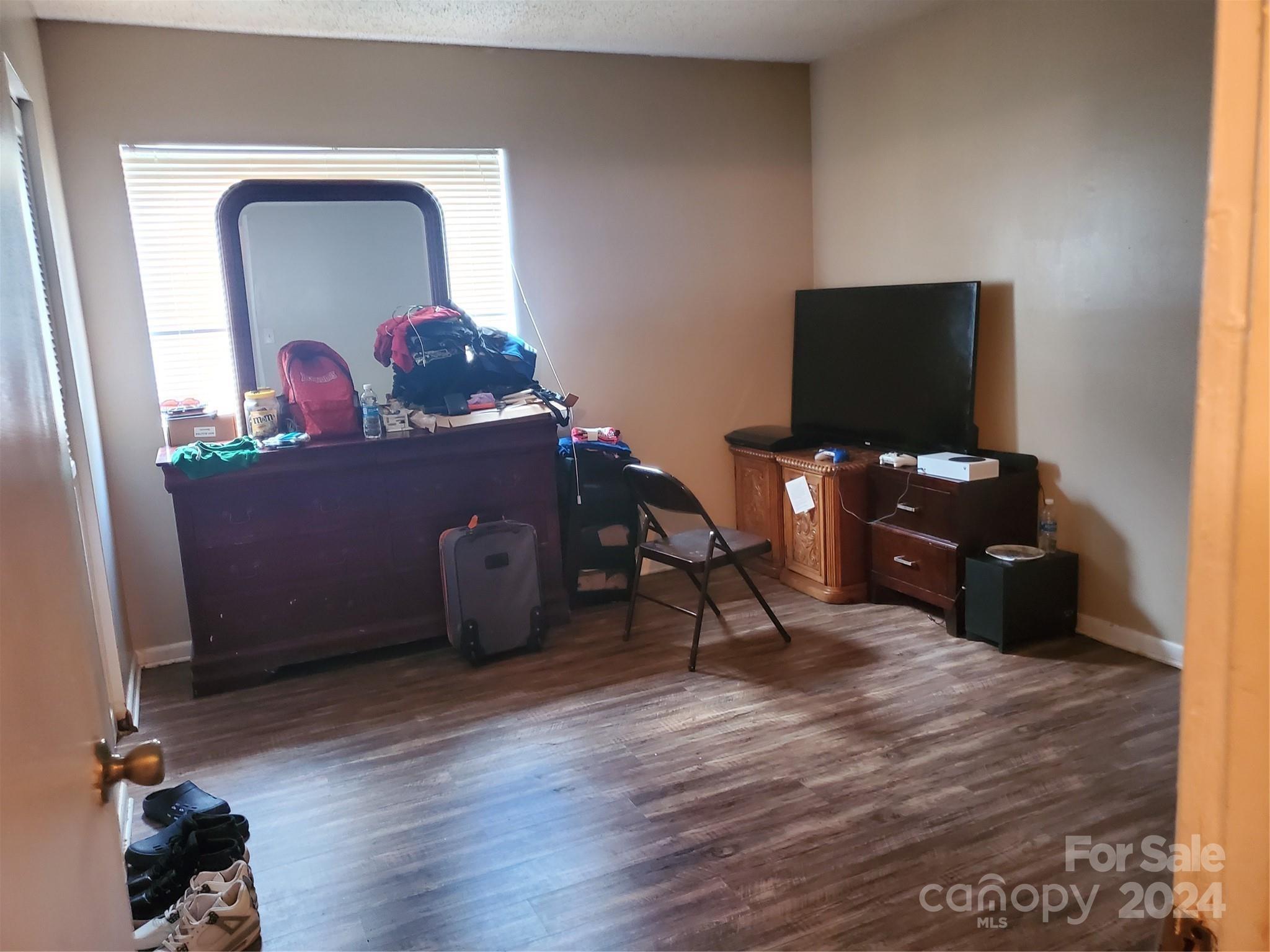 4804 Spring Lake Drive, Unit B Charlotte, NC 28212 - Photo 2 of 12 a living room with furniture and a flat screen tv