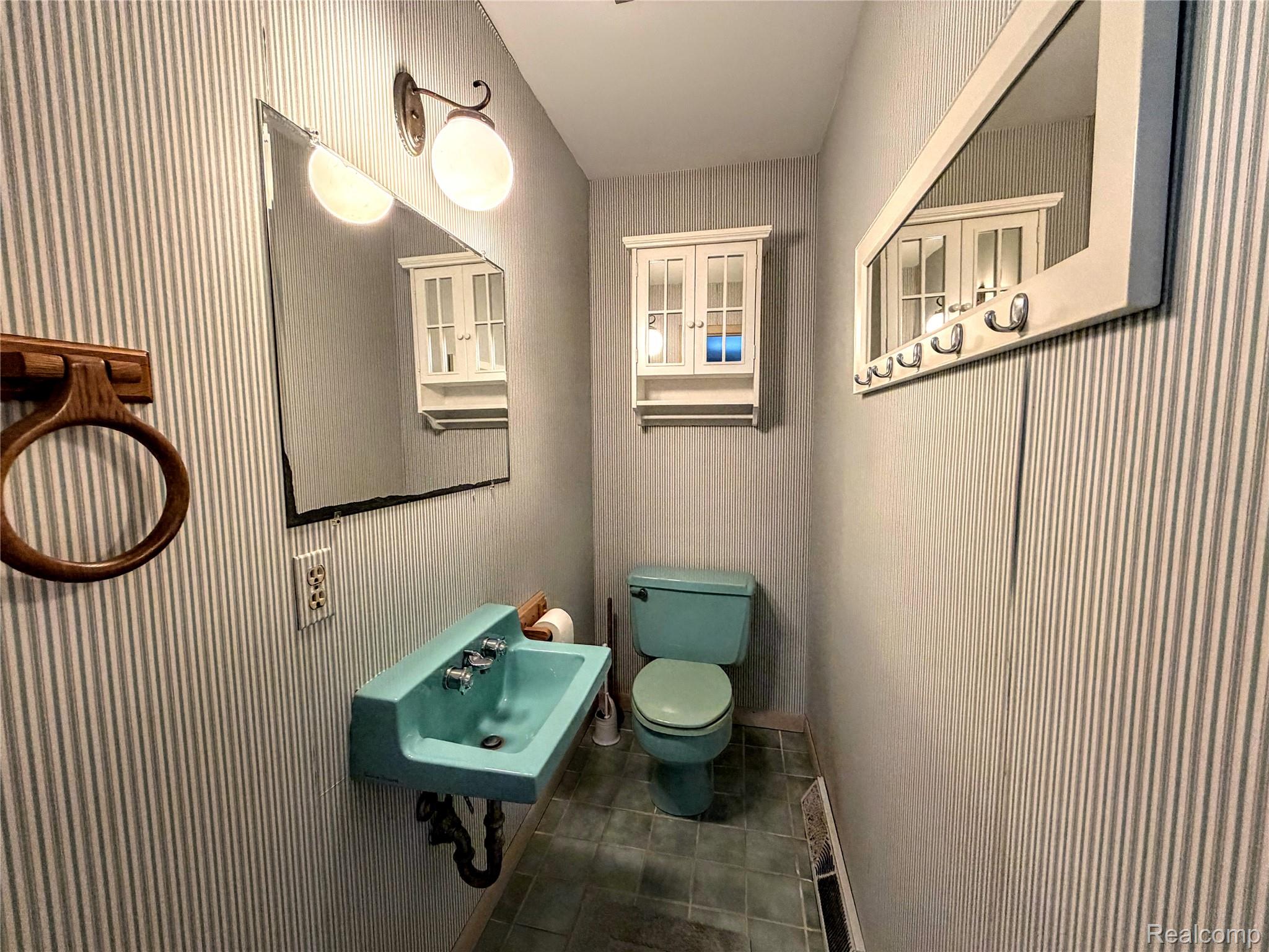 8079 Farley Road Pinckney, MI 48169 - Photo 20 of 43 Half bathroom featuring wallpapered walls and dark tile patterned floors