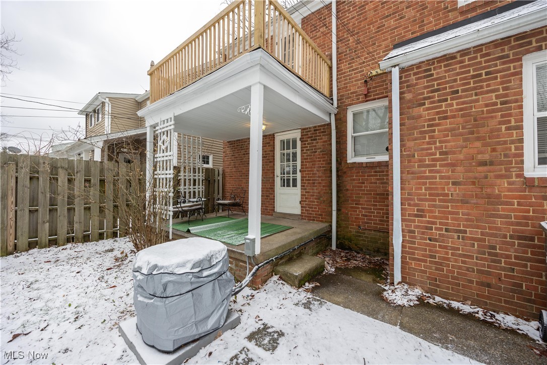 1937 Staunton Road Cleveland, OH 44118 - Photo 27 of 31 View of snowy exterior with brick siding, a patio area, and a deck