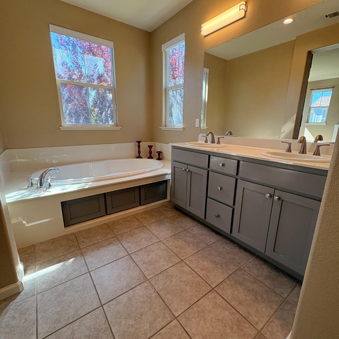 7969 Kipling Circle Gilroy, CA 95020 - Photo 11 of 19 a spacious bathroom with a double vanity sink a mirror and a bathtub