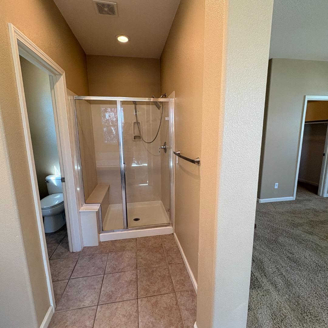 7969 Kipling Circle Gilroy, CA 95020 - Photo 13 of 19 a bathroom with a glass door shower and toilet