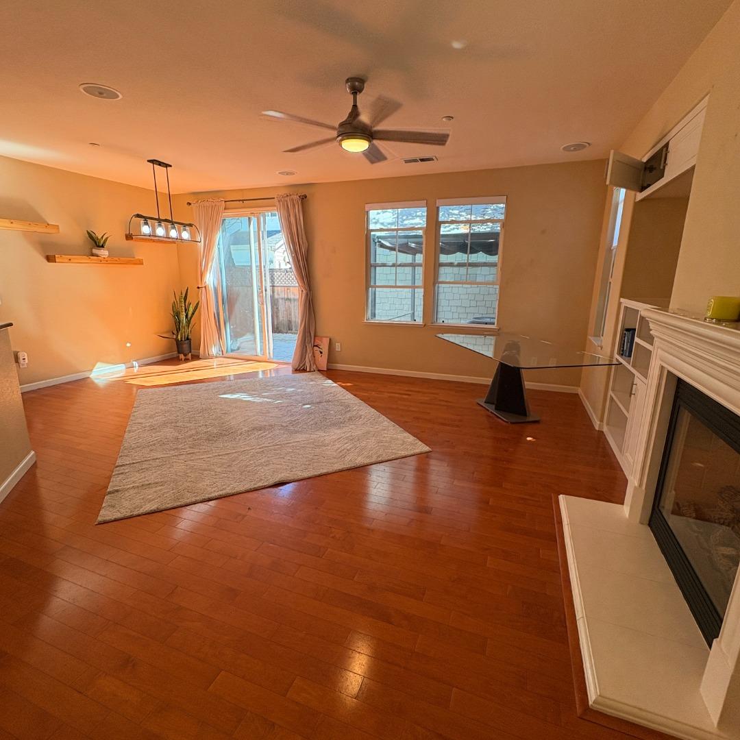 7969 Kipling Circle Gilroy, CA 95020 - Photo 3 of 19 a view of a livingroom with a fireplace and a ceiling fan