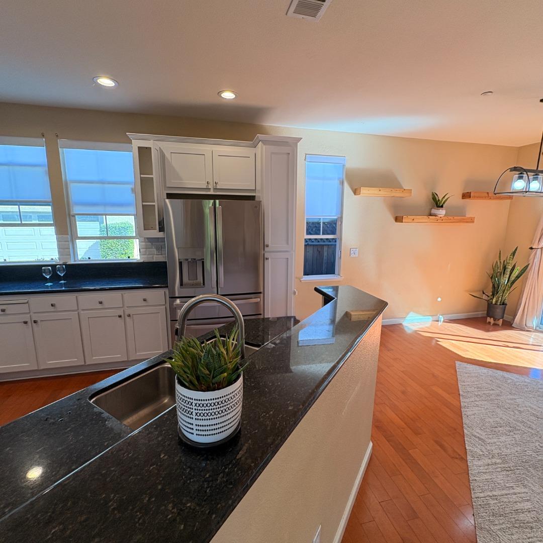 7969 Kipling Circle Gilroy, CA 95020 - Photo 6 of 19 a kitchen with a refrigerator and a blue sink