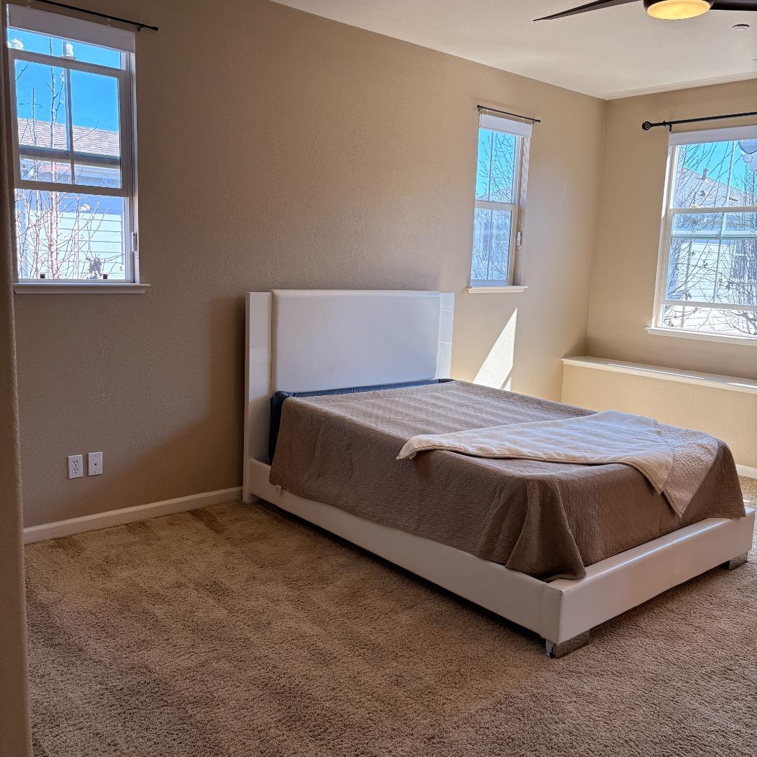 7969 Kipling Circle Gilroy, CA 95020 - Photo 8 of 19 a spacious bedroom with a bed and window
