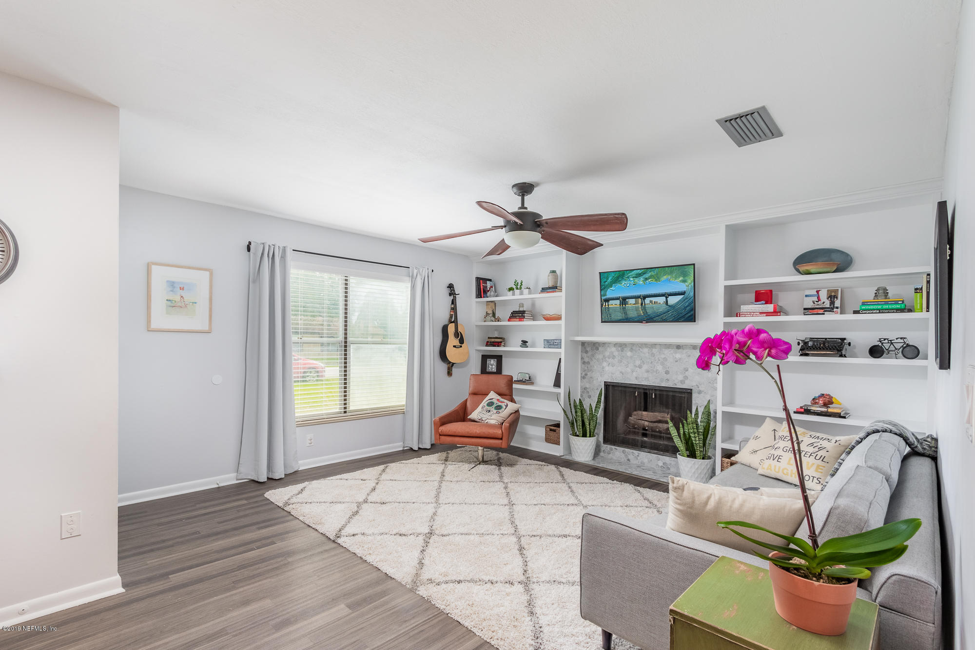 228 Lobelia Road St. Augustine, FL 32086 - Photo 5 of 27 a living room with fireplace furniture and a wooden floor