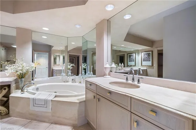a bathroom with a sink double vanity granite and a mirror