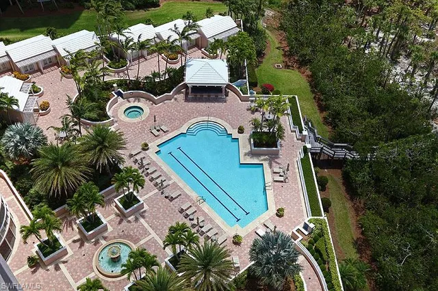 a view of a swimming pool with outdoor seating