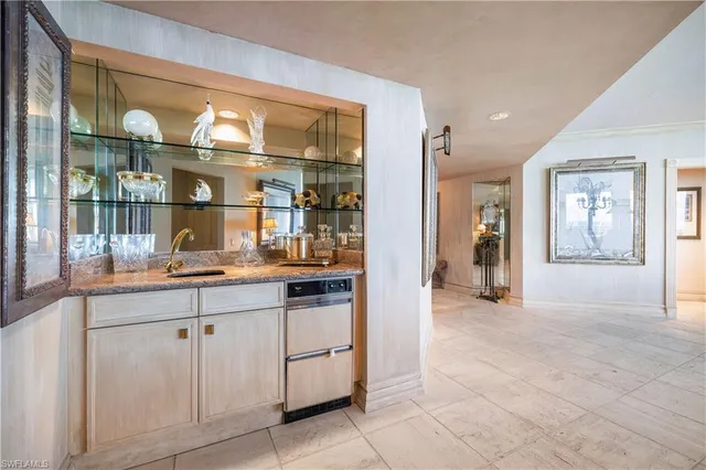 a open kitchen with granite countertop a sink and cabinets
