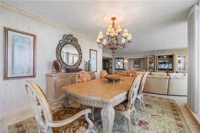 a view of a dining room with furniture and chandelier