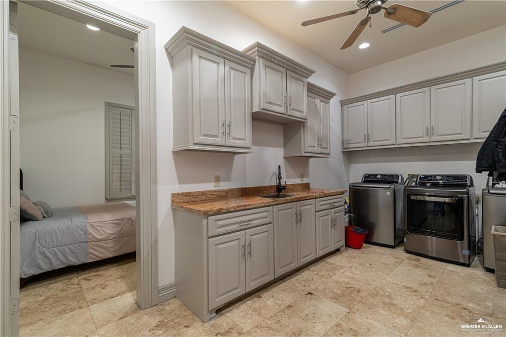 1205 Travis Street Mission, TX 78572 - Photo 31 of 45 a kitchen with stainless steel appliances granite countertop a stove and a sink