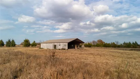 a view of a dry yard with wooden fence