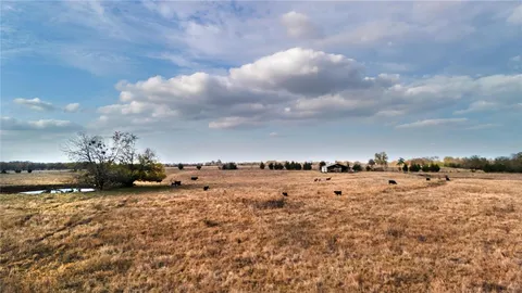 a view of a lake with beach and city in the back