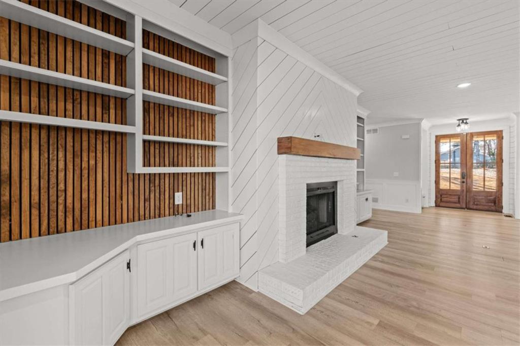 1127 Lakeshore Court Villa Rica, GA 30180 - Photo 15 of 86 a hallway with a fireplace and a book shelf