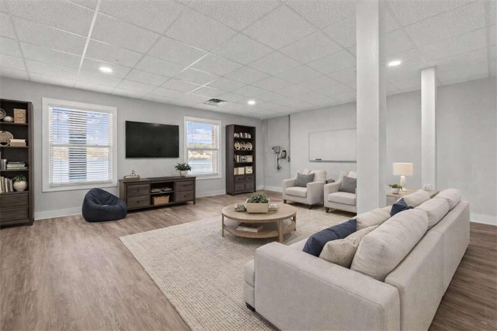 1127 Lakeshore Court Villa Rica, GA 30180 - Photo 44 of 86 a living room with furniture and a flat screen tv