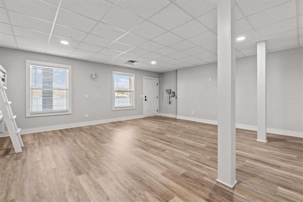 1127 Lakeshore Court Villa Rica, GA 30180 - Photo 45 of 86 an empty room with wooden floor and windows