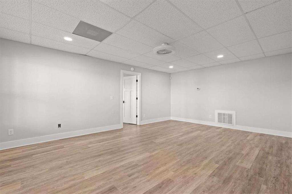 1127 Lakeshore Court Villa Rica, GA 30180 - Photo 47 of 86 an empty room with wooden floor and natural light