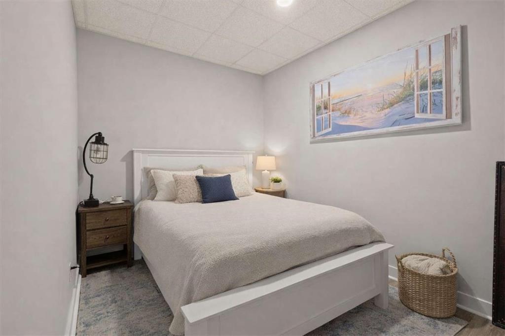 1127 Lakeshore Court Villa Rica, GA 30180 - Photo 48 of 86 a bedroom with a bed and a potted plant on the dresser