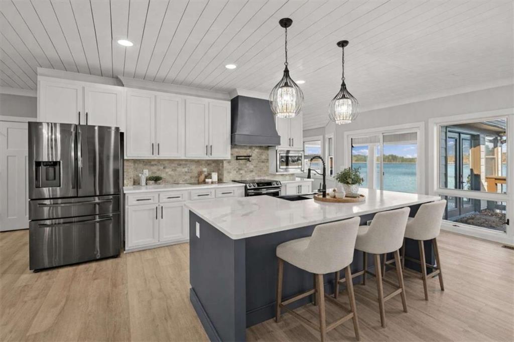 1127 Lakeshore Court Villa Rica, GA 30180 - Photo 8 of 86 a kitchen with stainless steel appliances granite countertop a sink a stove a refrigerator cabinets a dining table and chairs