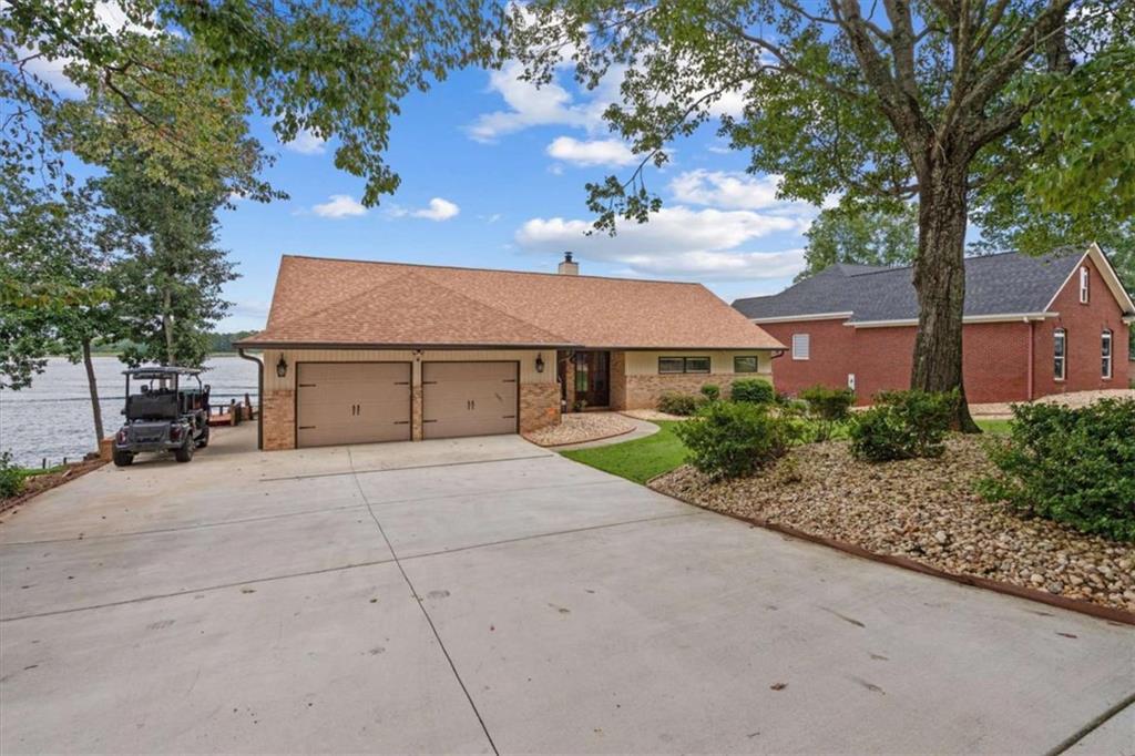 1127 Lakeshore Court Villa Rica, GA 30180 - Photo 82 of 86 a front view of a house with a yard and garage