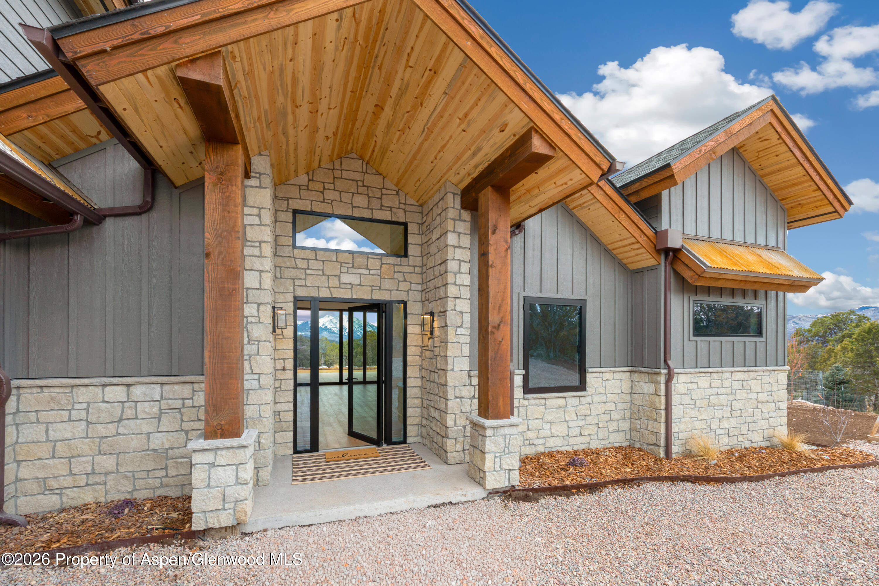 a view of a house with wooden fence