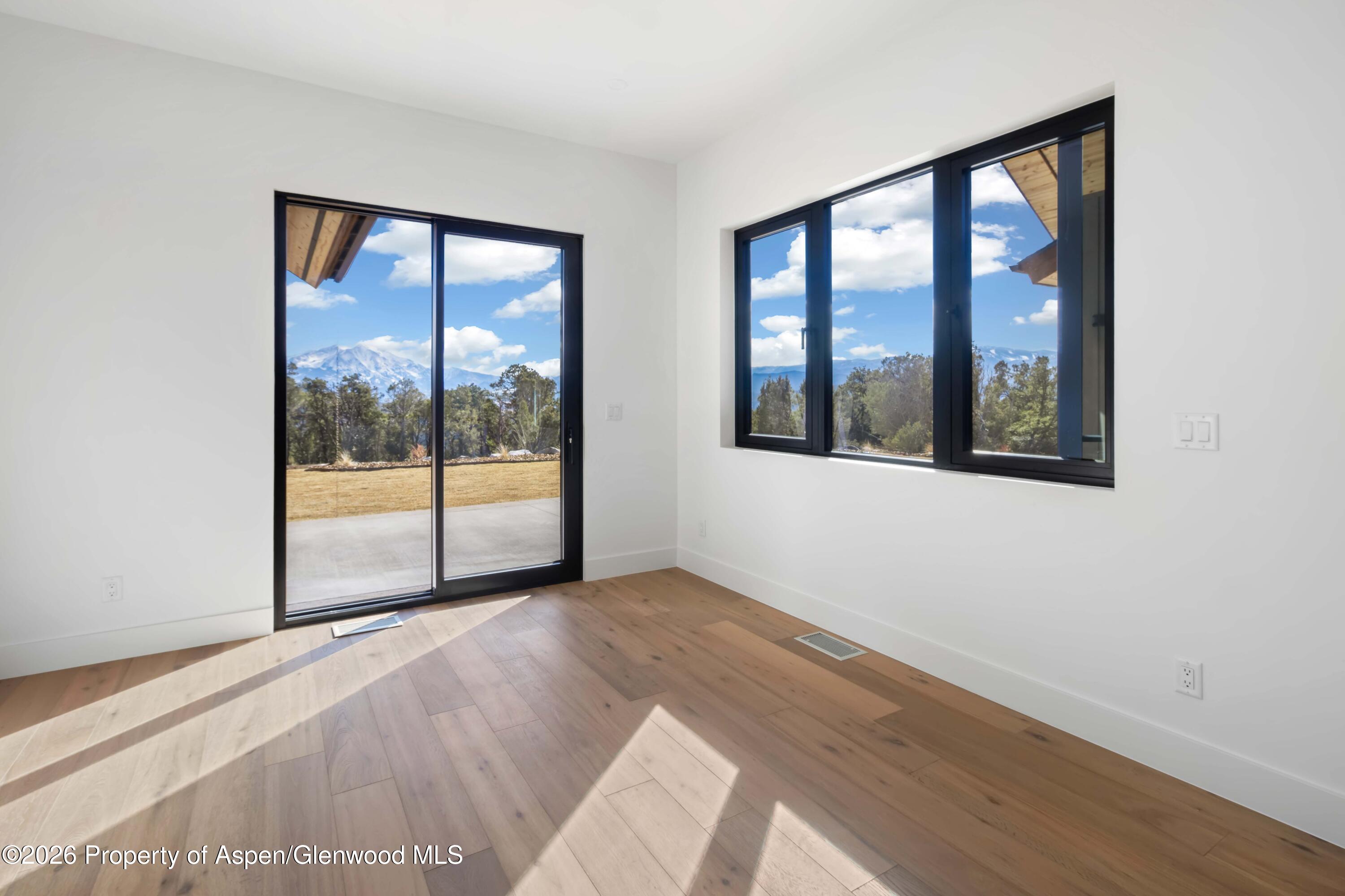38 Woodruff Road Glenwood Springs, CO 81601 - Photo 12 of 34 a view of an empty room with wooden floor and a window