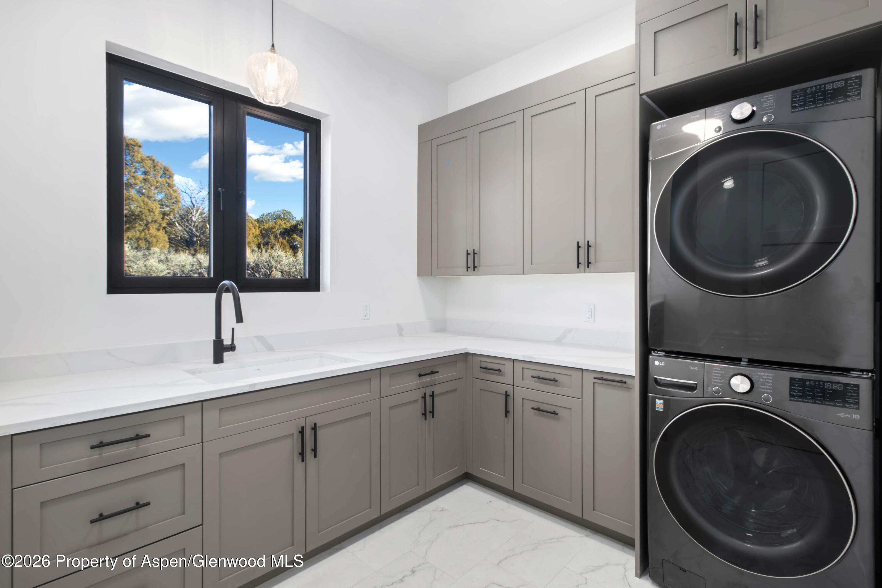 38 Woodruff Road Glenwood Springs, CO 81601 - Photo 14 of 34 a kitchen with a sink and a washer dryer