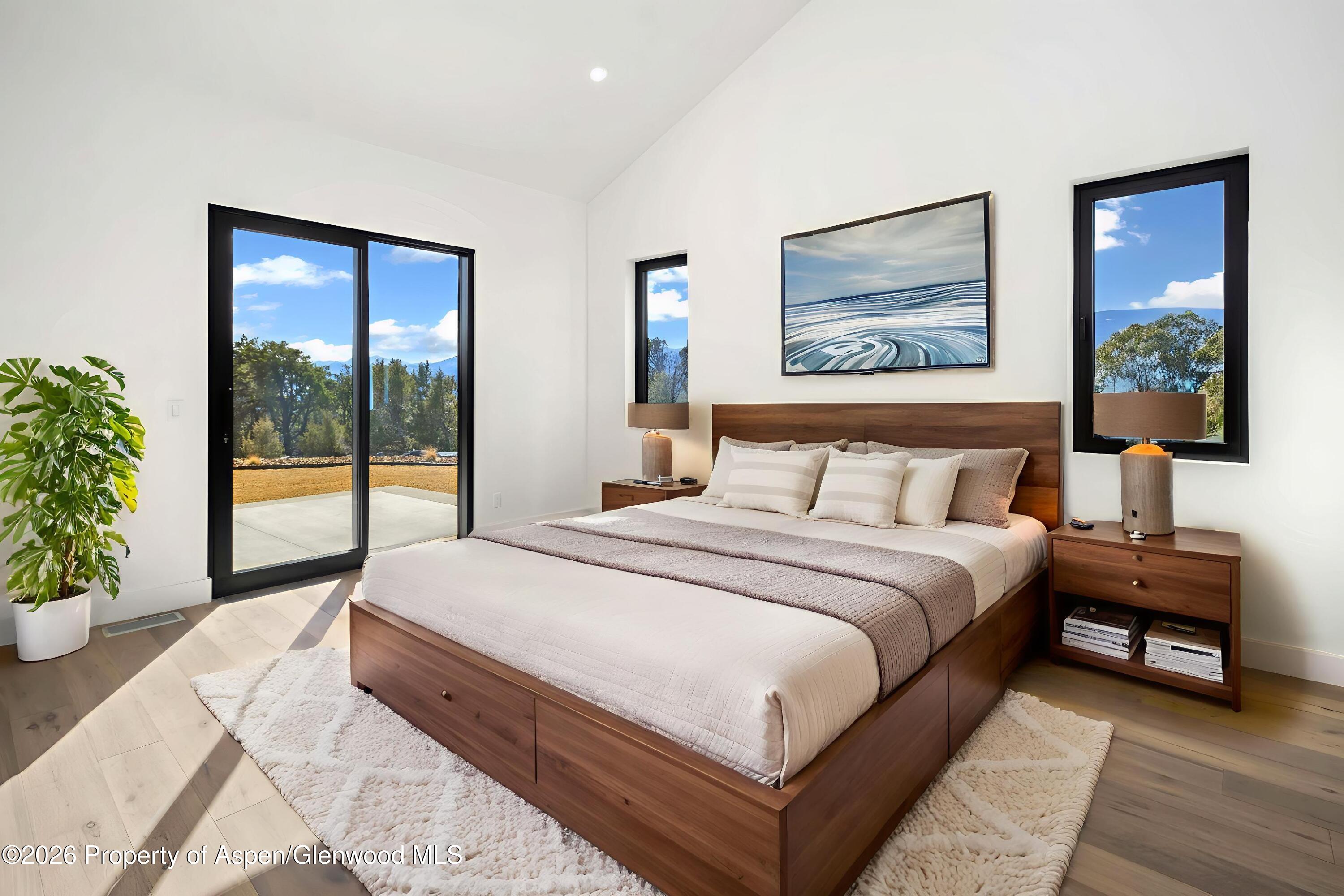 38 Woodruff Road Glenwood Springs, CO 81601 - Photo 17 of 34 a spacious bedroom with a large bed and a large window