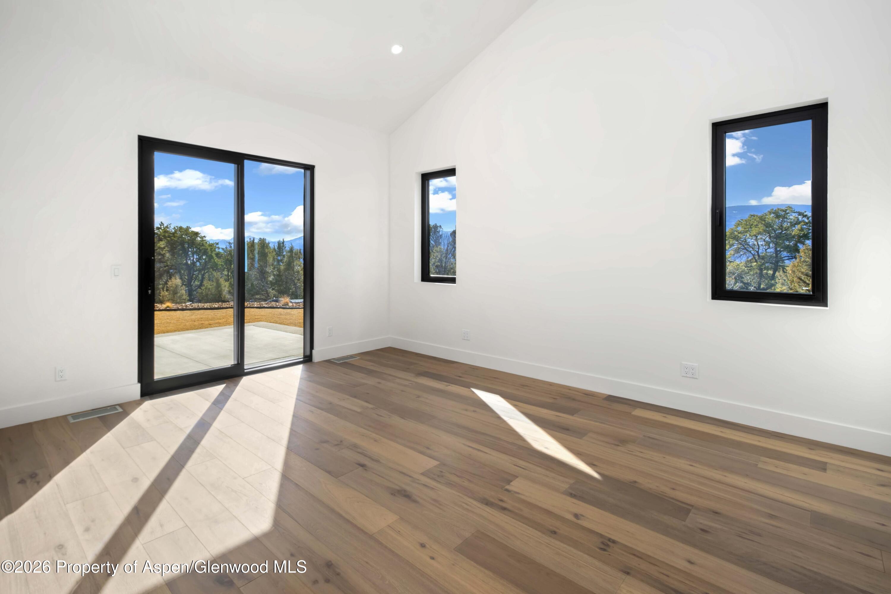 38 Woodruff Road Glenwood Springs, CO 81601 - Photo 18 of 34 an empty room with wooden floor and windows