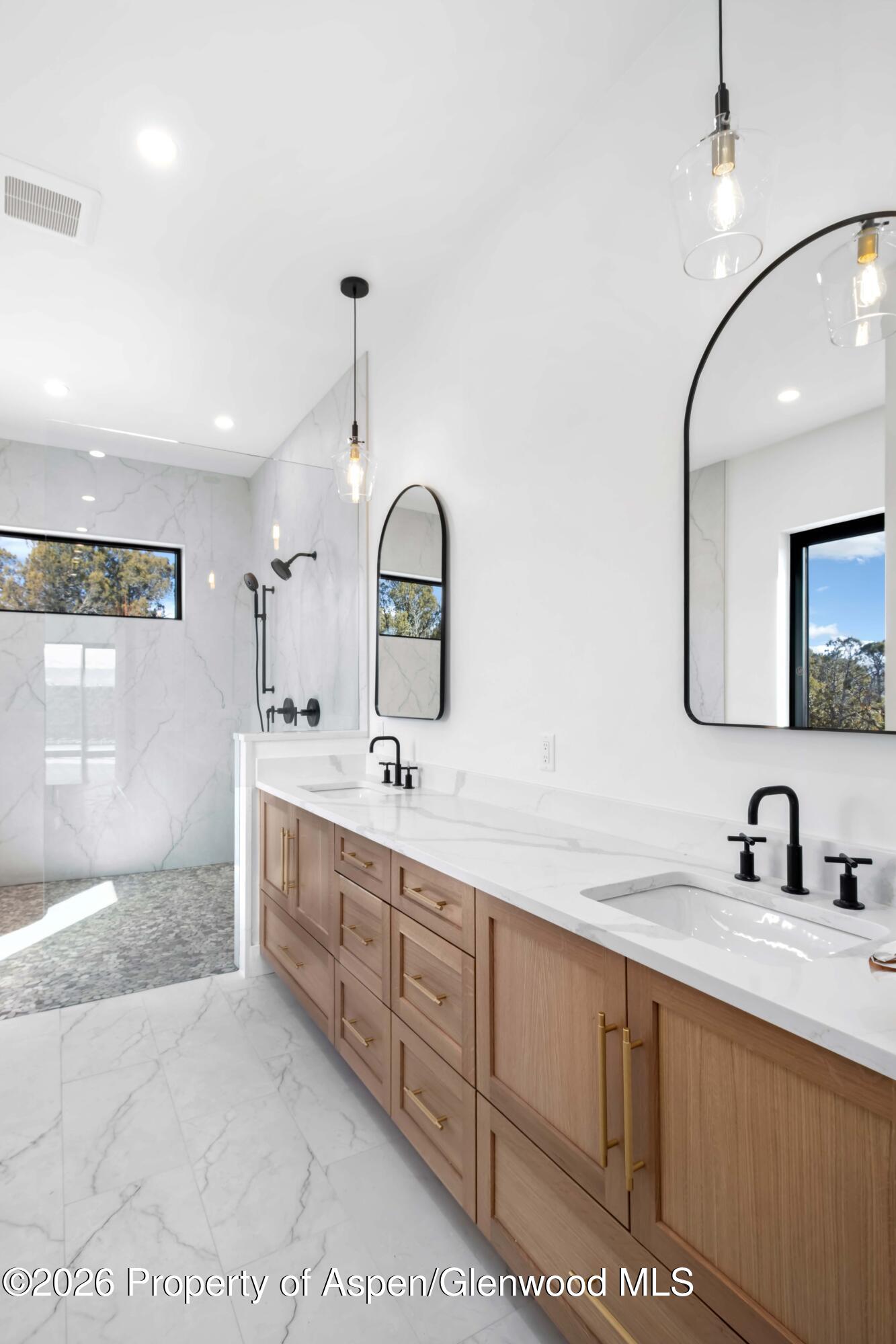 38 Woodruff Road Glenwood Springs, CO 81601 - Photo 19 of 34 a spacious bathroom with a double vanity sink a mirror and shower