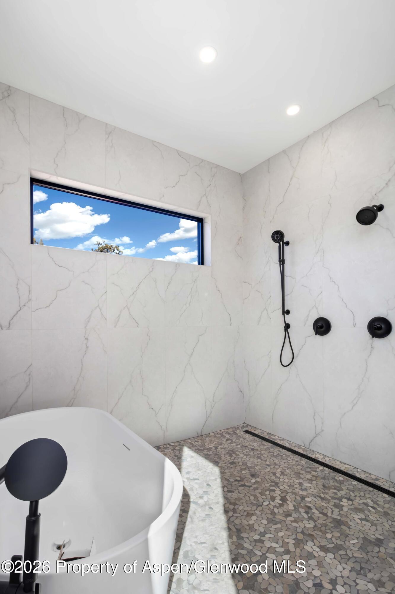 38 Woodruff Road Glenwood Springs, CO 81601 - Photo 20 of 34 a bathroom with a tub and a shower