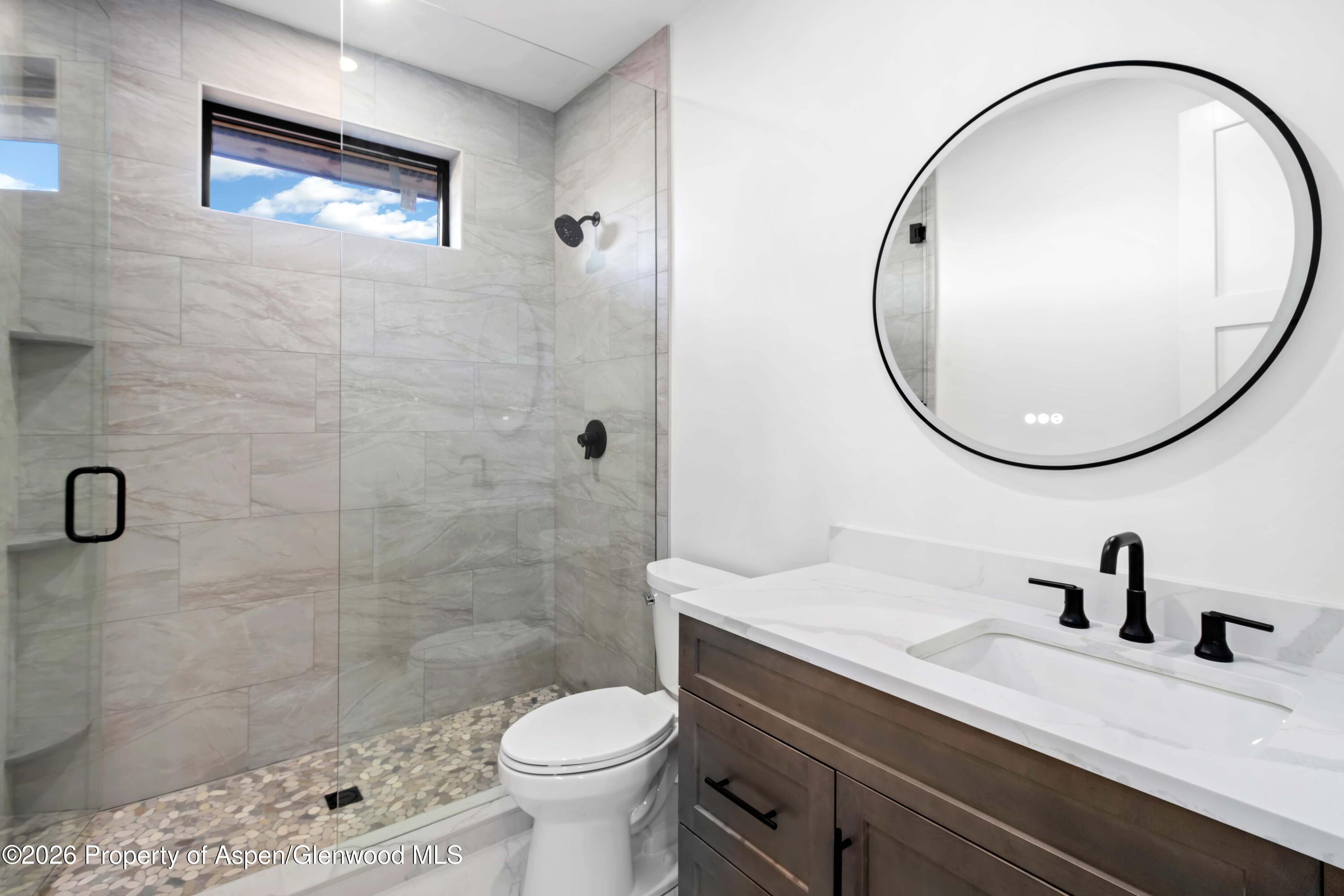 38 Woodruff Road Glenwood Springs, CO 81601 - Photo 27 of 34 a bathroom with a sink a toilet and a mirror