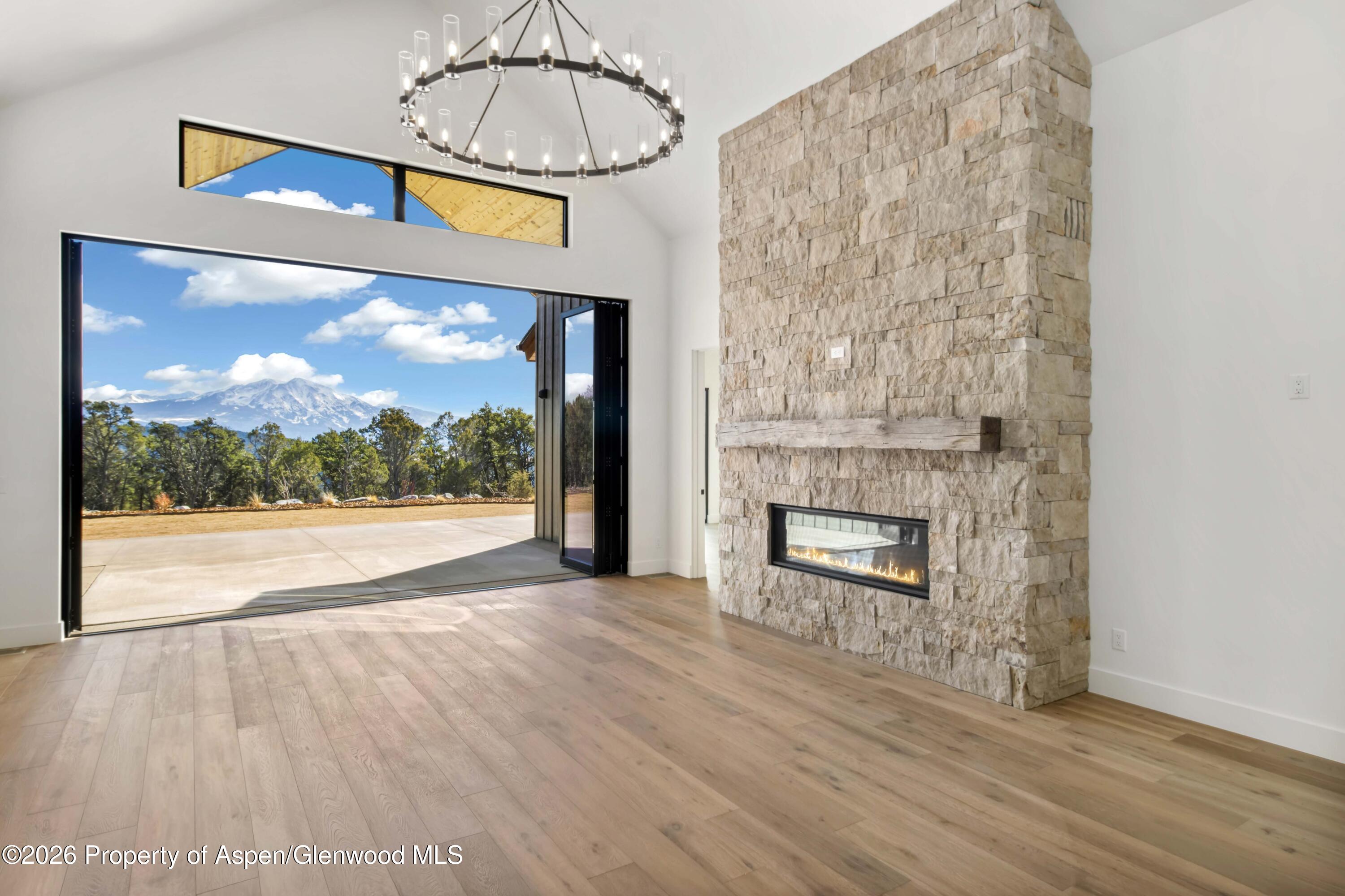 38 Woodruff Road Glenwood Springs, CO 81601 - Photo 5 of 34 a view of an empty room with wooden floor and a fireplace