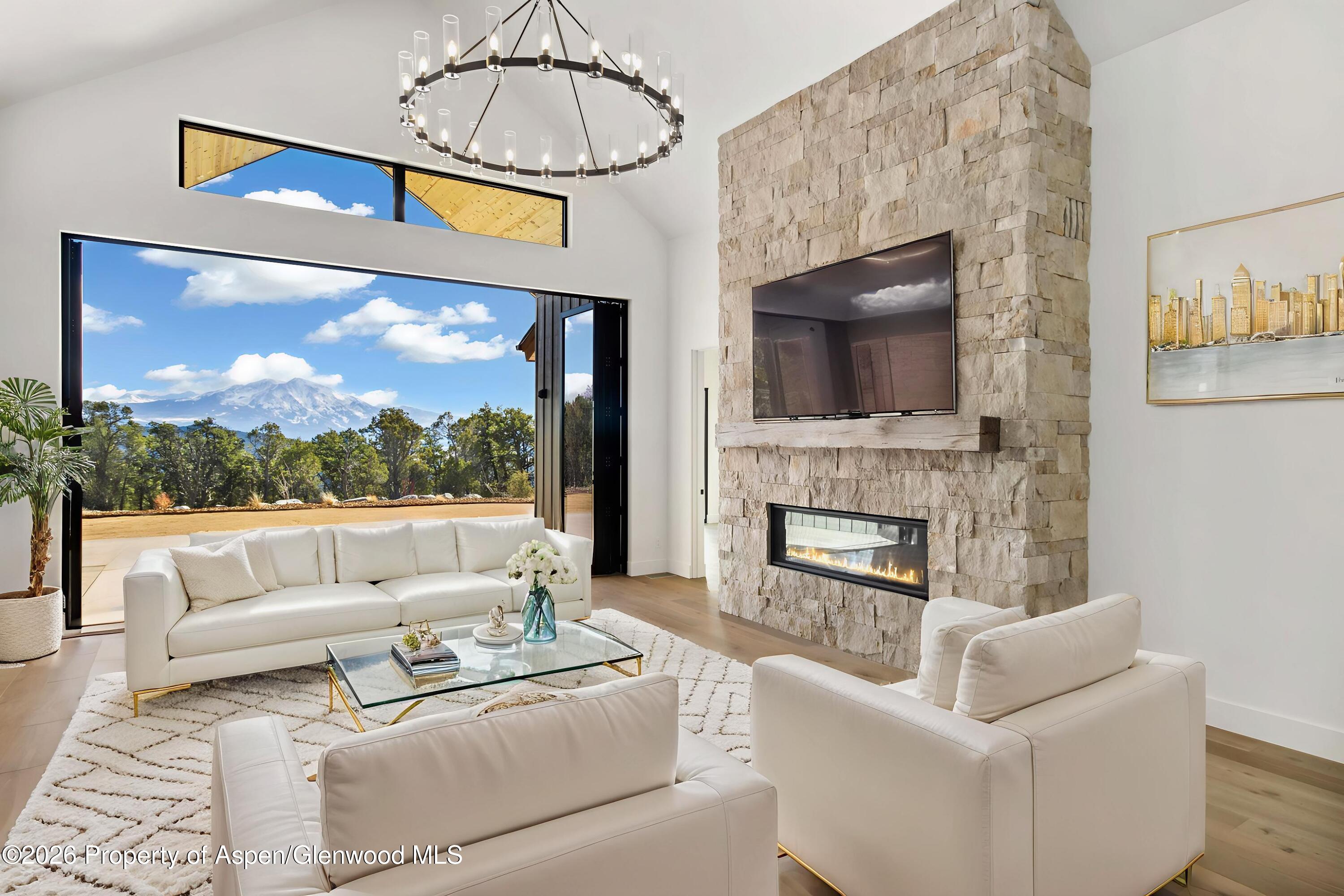 38 Woodruff Road Glenwood Springs, CO 81601 - Photo 6 of 34 a living room with furniture a fireplace and a flat screen tv