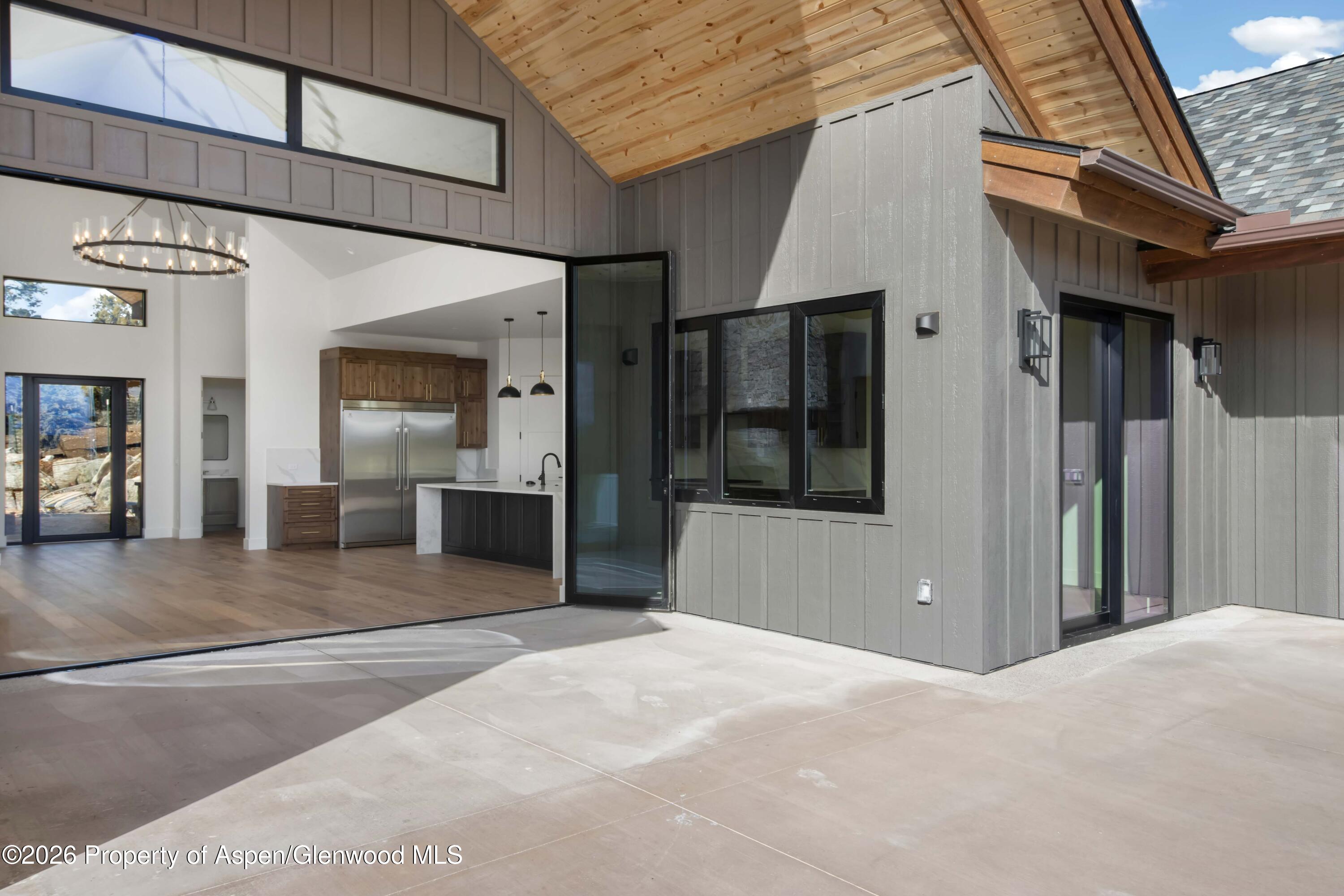 38 Woodruff Road Glenwood Springs, CO 81601 - Photo 7 of 34 a view of a hallway with wooden floor and a glass door