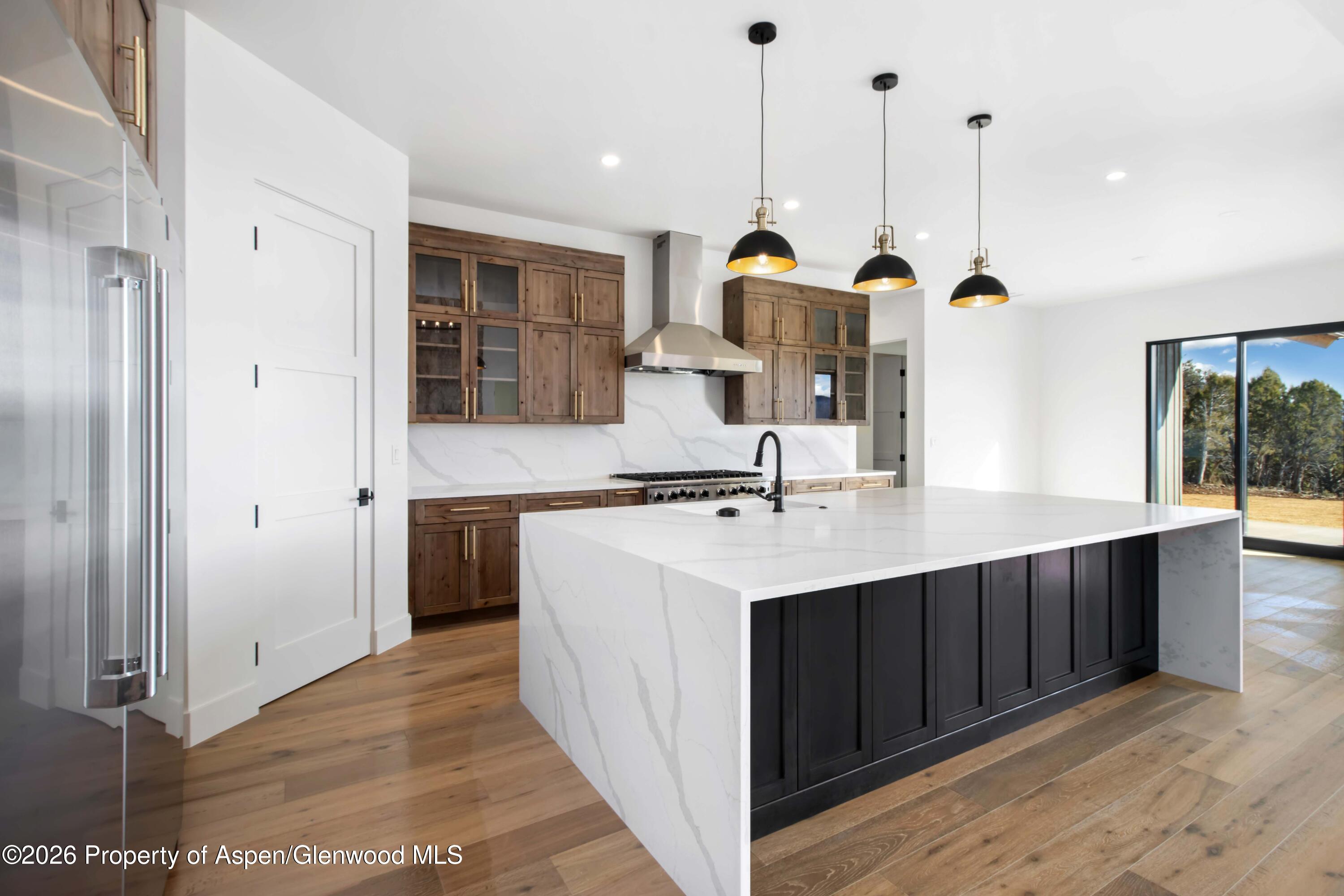 38 Woodruff Road Glenwood Springs, CO 81601 - Photo 9 of 34 a kitchen with a sink refrigerator and a view of living room
