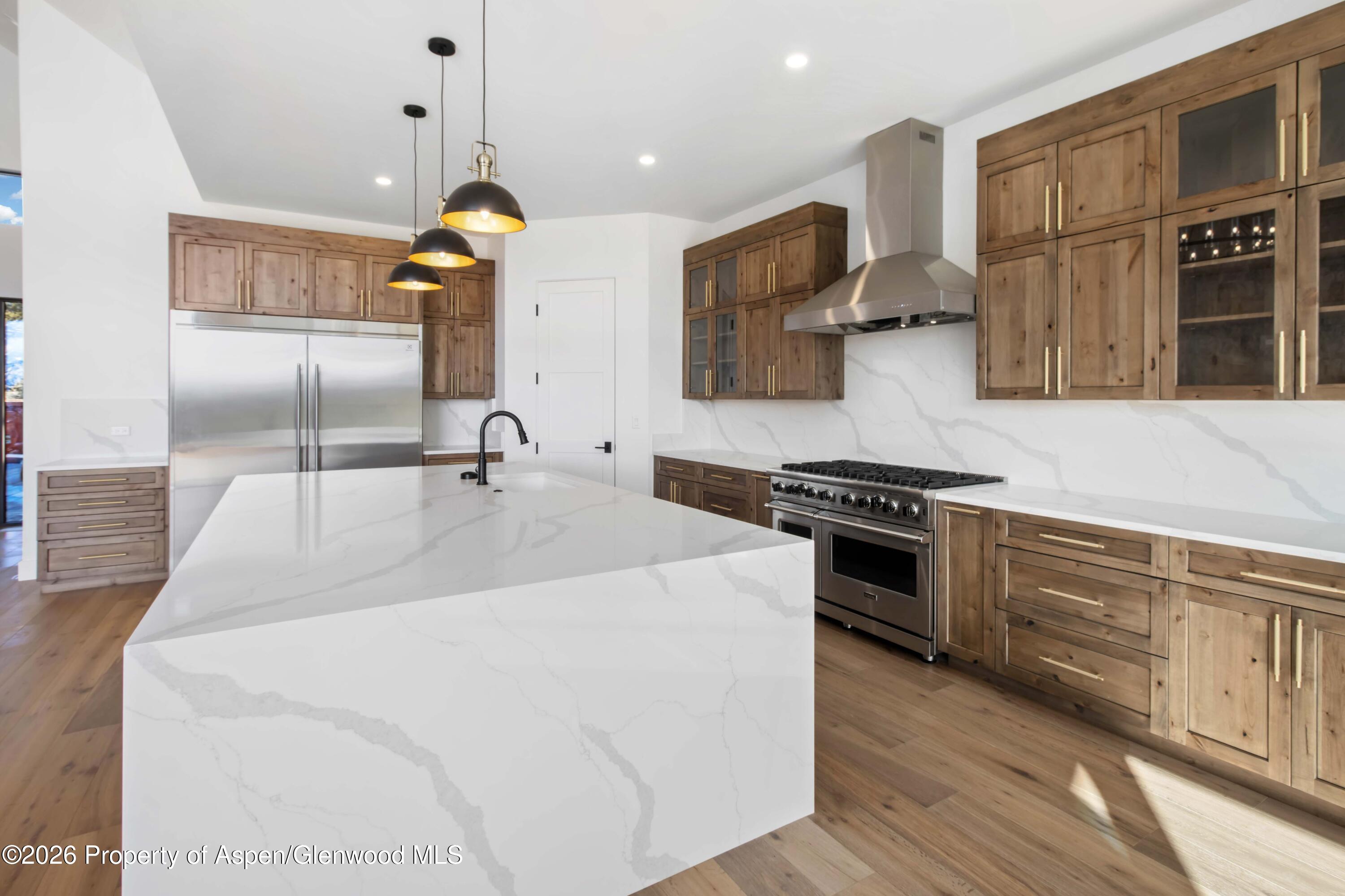 38 Woodruff Road Glenwood Springs, CO 81601 - Photo 10 of 34 a kitchen with stainless steel appliances granite countertop a sink a stove and a wooden floors