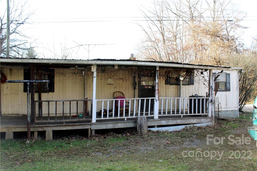 541 Incinerator Road Clyde, NC 28721 - Photo 1 of 11 a view of a wooden deck that has a bench and wooden fence