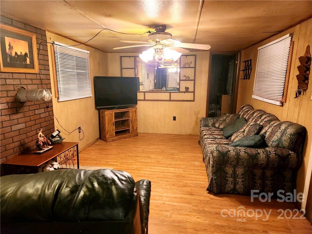 541 Incinerator Road Clyde, NC 28721 - Photo 2 of 11 a living room with furniture and a flat screen tv