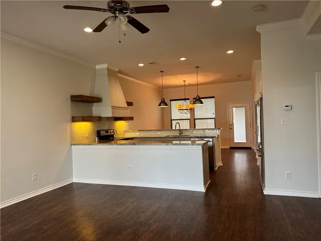 a view of a kitchen with a sink and a refrigerator