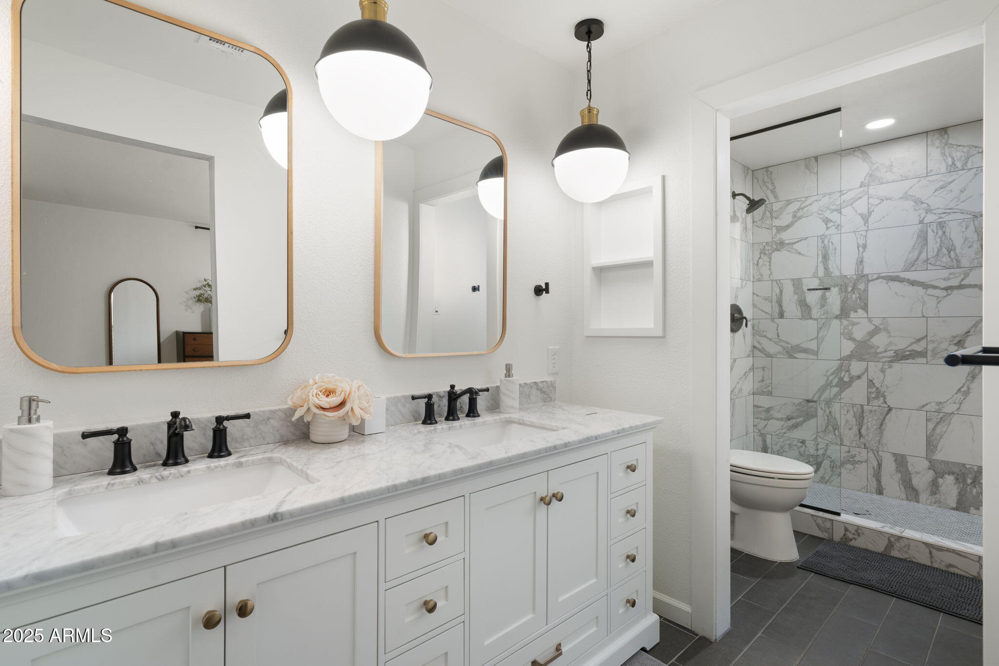 5142 East Nisbet Road Scottsdale, AZ 85254 - Photo 23 of 54 a bathroom with double vanity sinks a toilet a mirror and shower