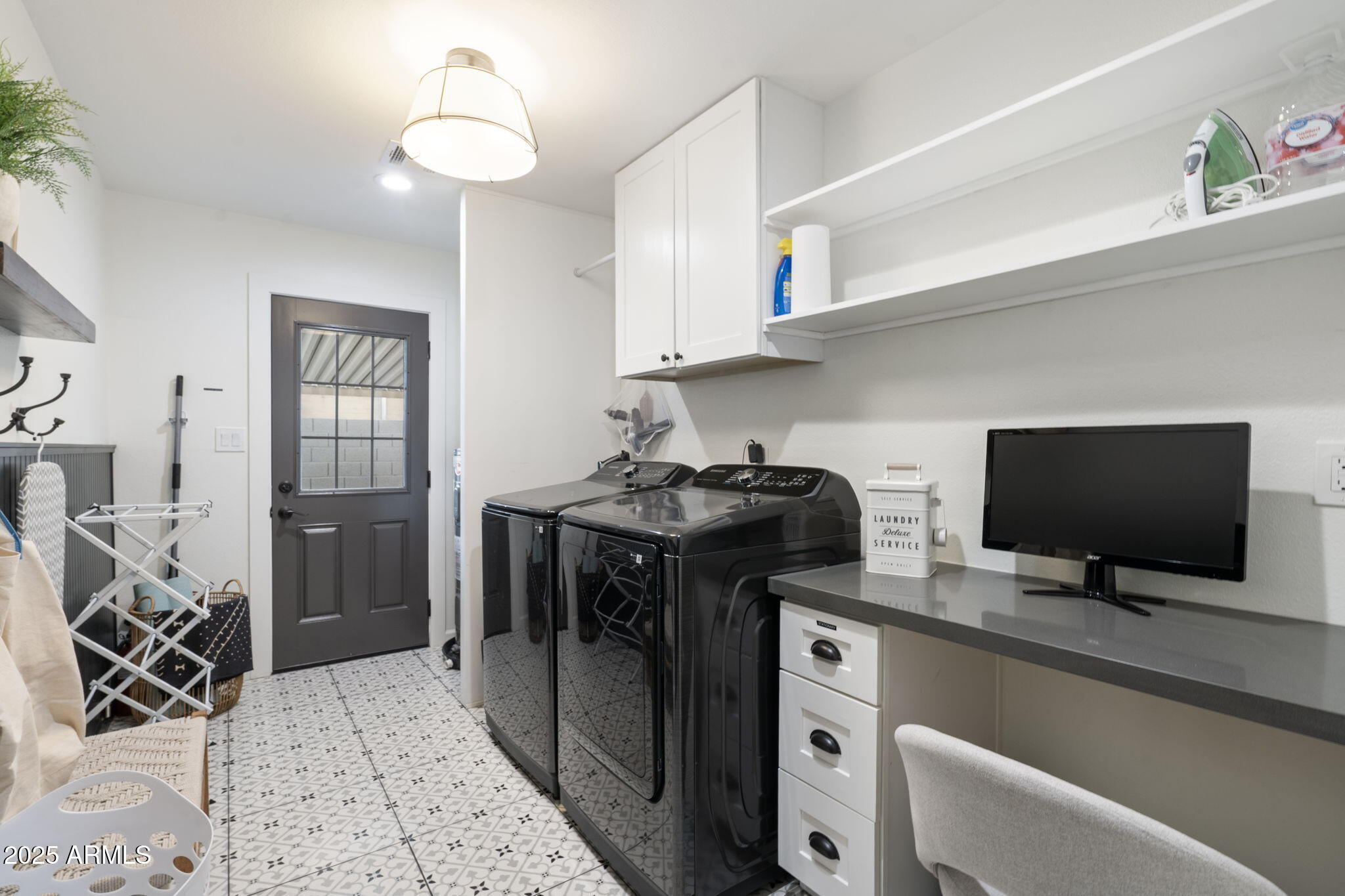 5142 East Nisbet Road Scottsdale, AZ 85254 - Photo 33 of 54 a view of a workspace with furniture and a flat screen tv