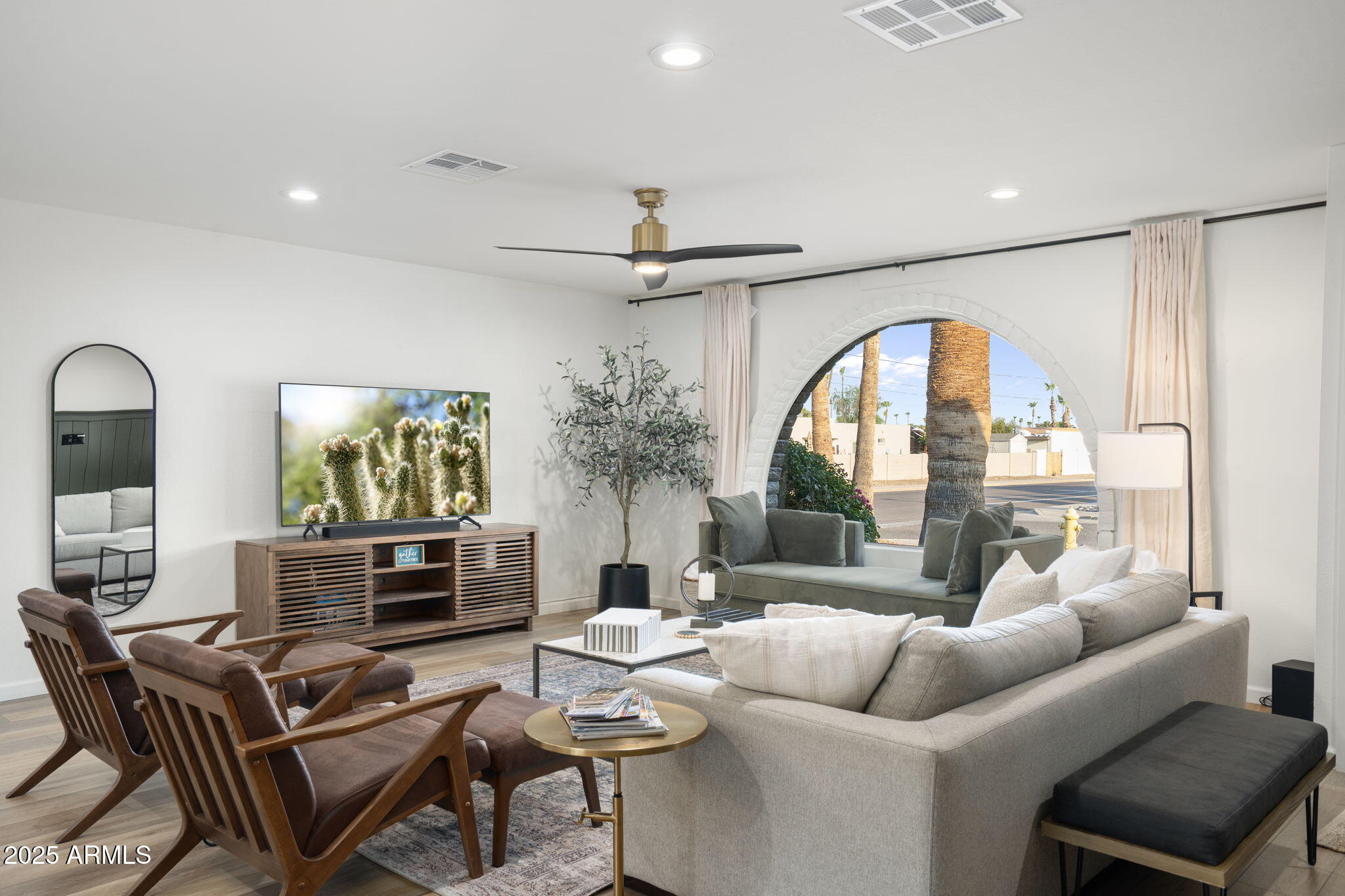 5142 East Nisbet Road Scottsdale, AZ 85254 - Photo 4 of 54 a living room with furniture a fireplace and a chandelier
